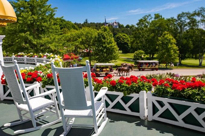 Rocking Relaxation: Enjoy Scenic Lemonade Sipping in Classic White Chairs